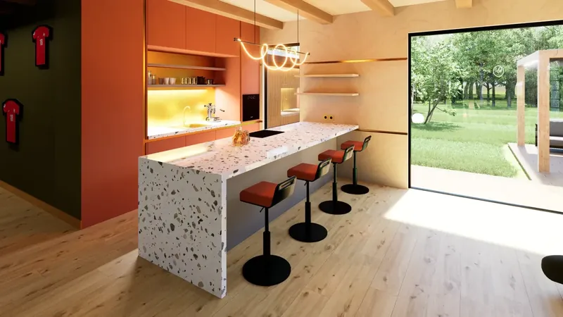 Szczedrzyk house: terracotta kitchen with a terrazzo bar, orange stools and a wave pendant, opening onto the garden